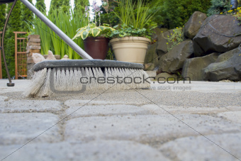 Broom Sweeping Sand into Pavers Low View