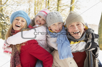 Family Having Fun Snowy Woodland