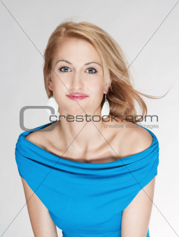 portrait of a young beautiful blond woman - isolated on light gray