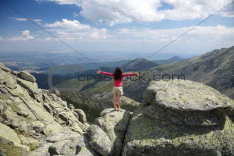 cross arms woman on sunny rock