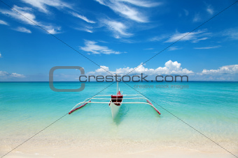White boat on a tropical beach 