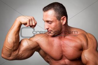 Muscular man flexing his biceps 
