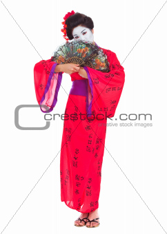 Full length portrait of geisha hiding behind fans isolated on white