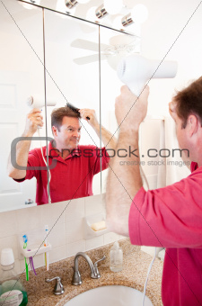 Man Blow Drying Hair in Bathroom