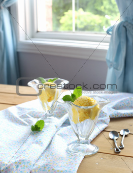 Mango ice cream in glass bowl
