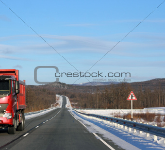 The red truck on a winter road.
