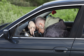 Drunk man asleep at the wheel