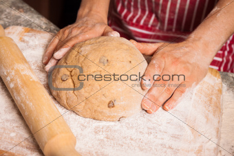 Hands on a dough