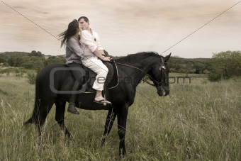 couple and  horse in a field