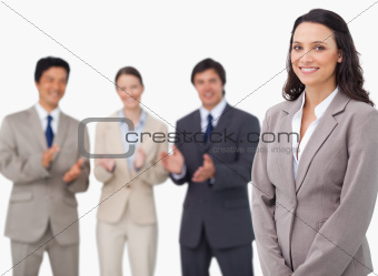 Saleswoman getting applause from her colleagues