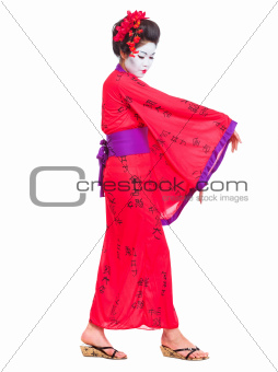 Full length portrait of geisha dancing isolated on white