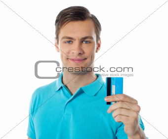 Close-up of handsome guy holding a credit card
