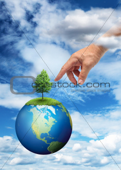 Hand reaching planet Earth