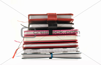 Close up of stacked up books on a white background