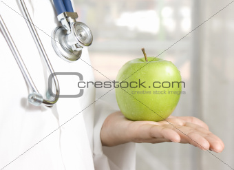 doctor holding a green apple