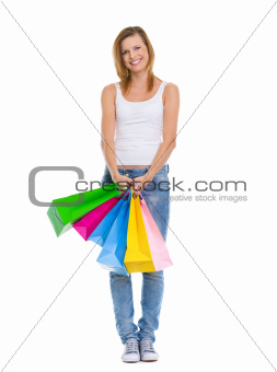 Full length portrait of smiling teenage girl with shopping bags