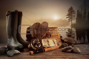 Fly fishing equipment on deck with view of a misty lake