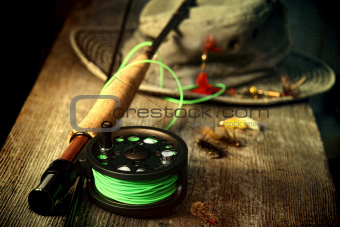 Fly fishing equipment with old hat on bench