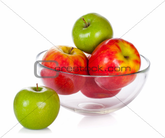 Glass bowl with apples isolated on white