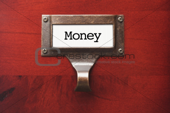 Lustrous Wooden Cabinet with Money File Label in Dramatic LIght.