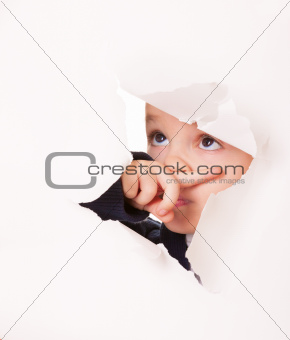 Guilty looking kid in a hole in white paper