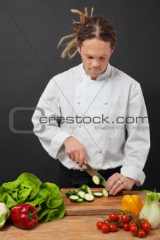 Chef with dreadlocks chopping