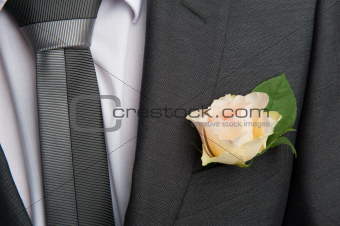 rose boutonniere flower on groom's wedding coat