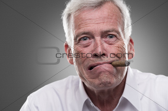 Puzzled senior man on gray background