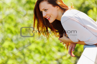 Smiling woman looking on copyspace on spring day
