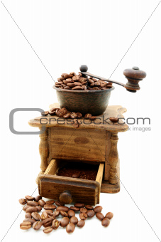 Old wooden mill with coffee beans.