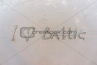 I love Baltic. Inscription on white sand of Baltic beach.