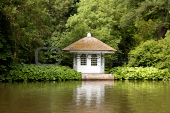 little house in rich garden on the embankment of the river