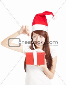young woman trying to open christmas gift box
