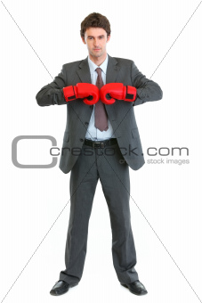 Full length portrait of businessman in boxing gloves