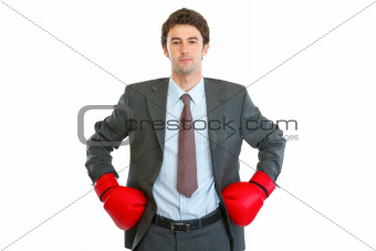 Serious businessman in boxing gloves