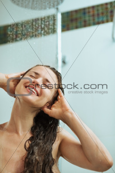 Happy woman taking shower