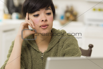Pretty Mixed Race Woman Using Laptop at Her Home.