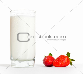 glass of milk and two strawberries