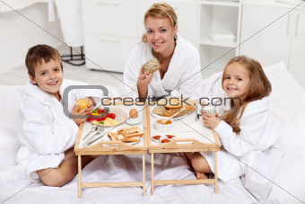 Happy morning - family having a light brekfast in bed