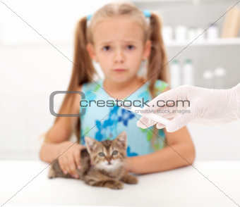 Little girl afraid for her kitten getting a vaccine at the veter