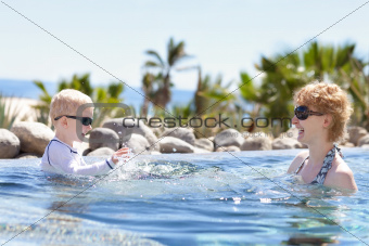 mother and son splashing