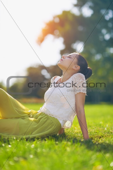 Young woman relaxing on meadow