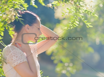 Thoughtful young woman relaxing in forest