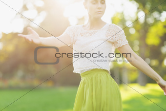 Young woman dancing on forest. Rear view