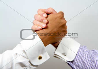 Handclasp between smartly dressed businessmen