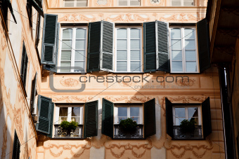 Bright Sunlit Painted House Facade in Genoa, Italy