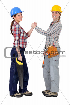 Female construction workers forming a pact