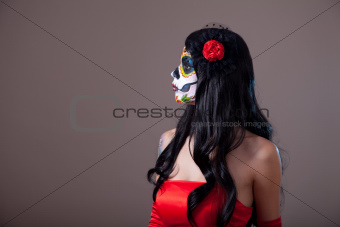 Profile view of Sugar skull girl in red dress 