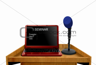 microphone and laptop on podium at seminar