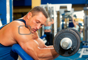 Man with weight training equipment on sport club 